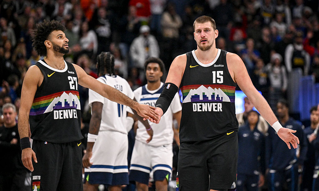 DENVER , CO - DECEMBER 26: Nikola Jokic (15) and Jamal Murray (27) of the Denver Nuggets shake hand...