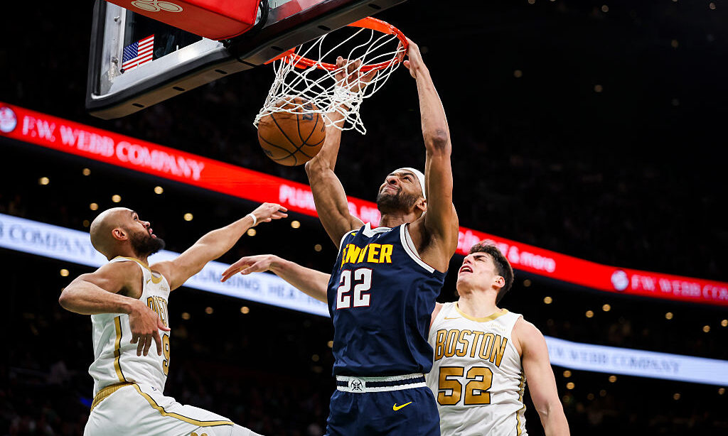BOSTON, MA - JANUARY 7: Zeke Nnaji #22 of the Denver Nuggets dunks the ball over Derrick White #9 o...