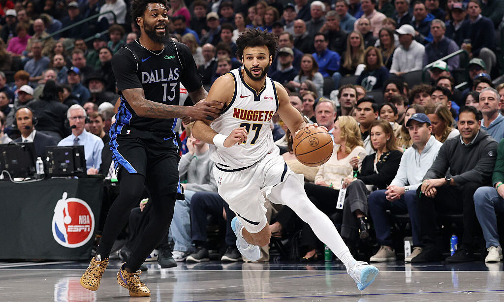 DALLAS, TEXAS - JANUARY 14: Jamal Murray #27 of the Denver Nuggets drives around Naji Marshall #13 ...
