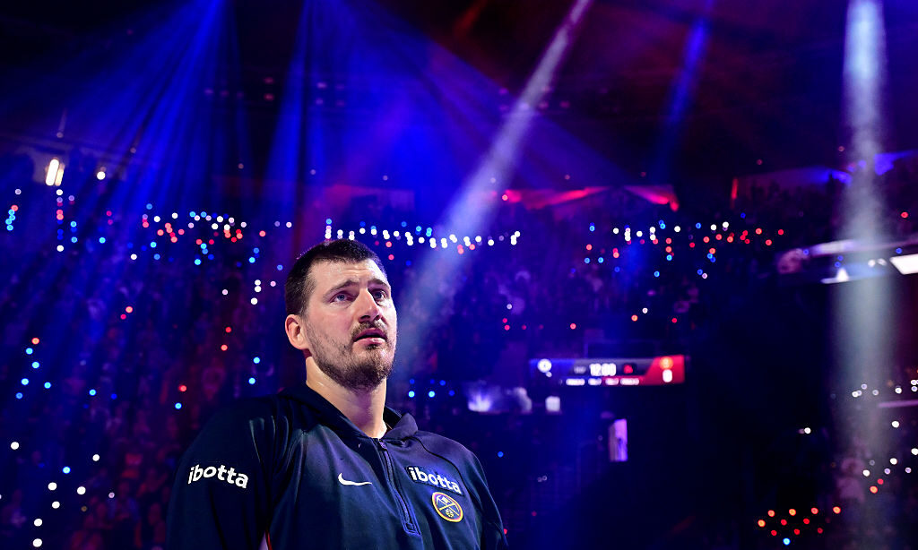INGLEWOOD, CALIFORNIA - FEBRUARY 19: Nikola Jokic #15 of the Denver Nuggets listens to the national...