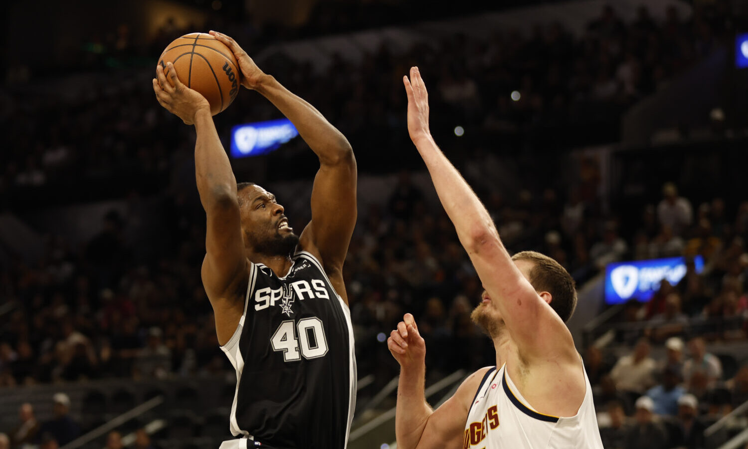 SAN ANTONIO, TX -MARCH 12: Harrison Barnes #40 of the San Antonio Spurs shots over Nikola Jokic #15...