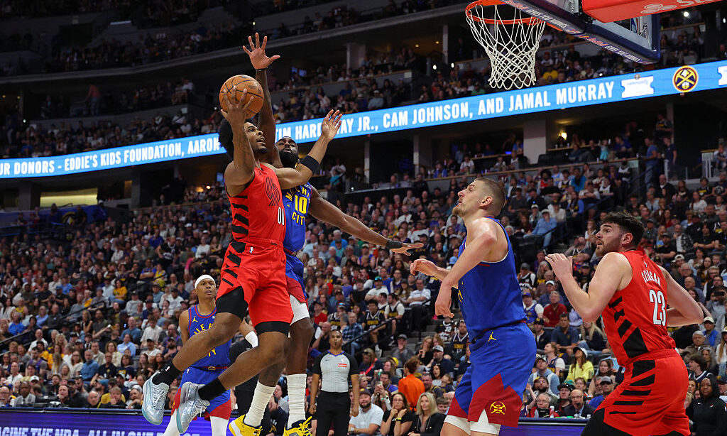 DENVER, COLORADO - MARCH 22: Scoot Henderson #00 of the Portland Trail Blazers drives to the basket...