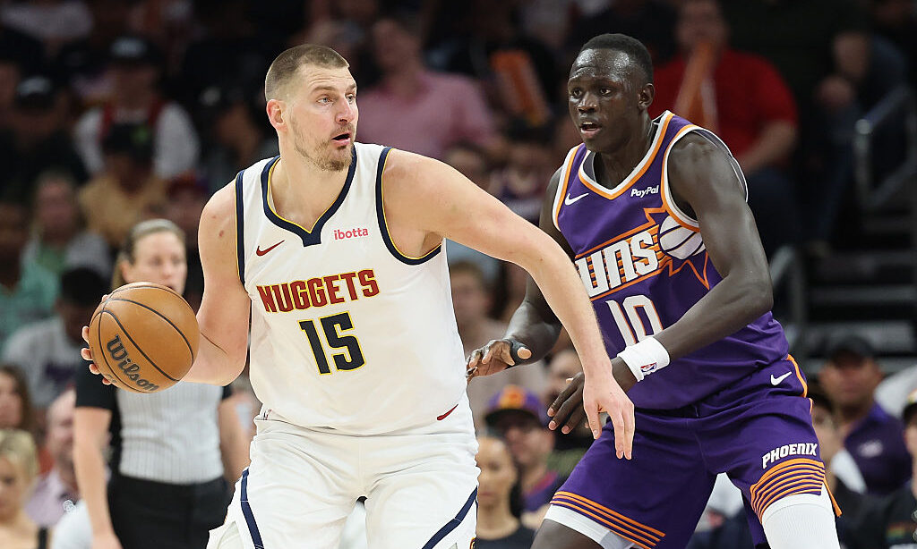 PHOENIX, ARIZONA - MARCH 24: Nikola Jokic #15 of the Denver Nuggets handles the ball against Khaman...
