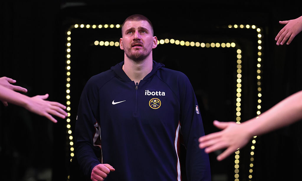 PHOENIX, ARIZONA - MARCH 24: Nikola Jokic #15 of the Denver Nuggets walks onto the court during the...