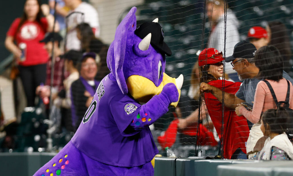 DENVER, CO - APRIL 10: Colorado Rockies mascot Dinger interacts with fans after the game against th...