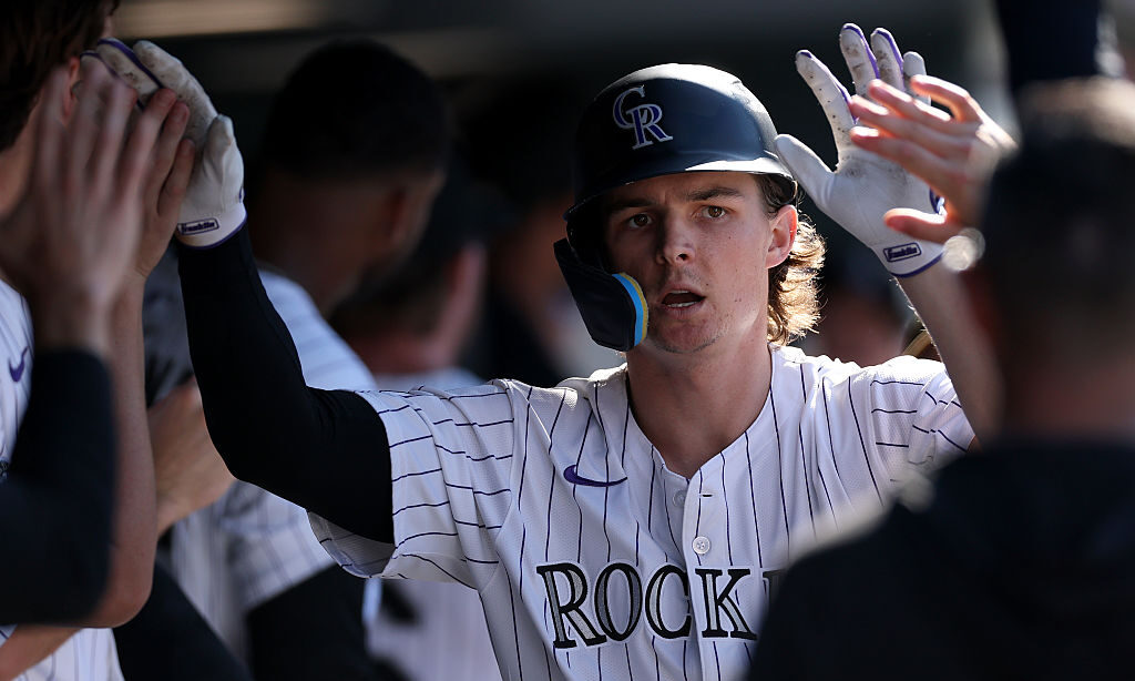 DENVER, COLORADO - SEPTEMBER 18: Mickey Moniak #22 of the Colorado Rockies celebrates in the dugout...