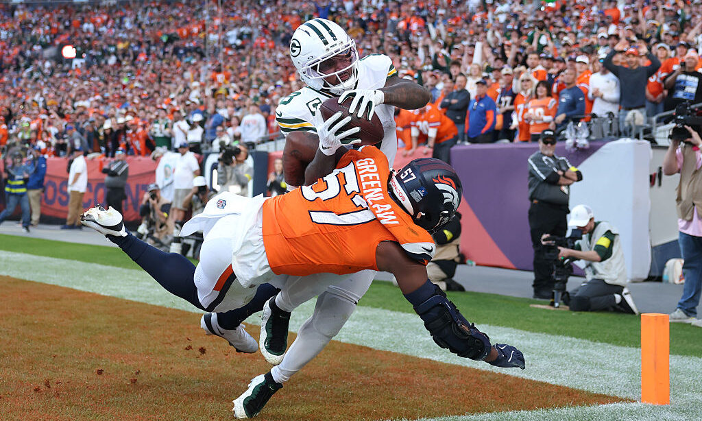 DENVER, COLORADO - DECEMBER 14: Josh Jacobs #8 of the Green Bay Packers catches a touchdown pass ag...