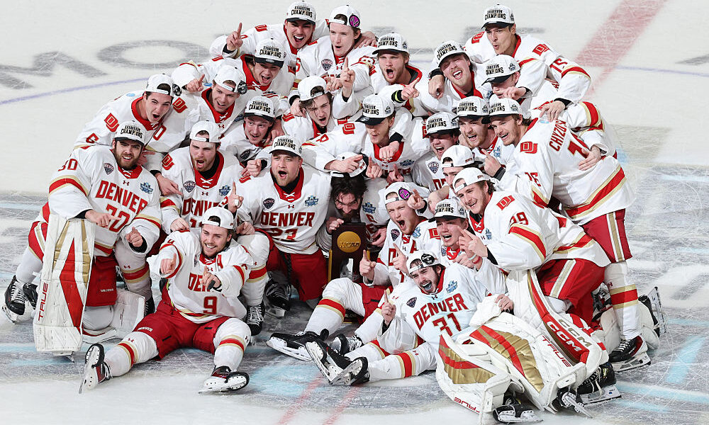 LAS VEGAS, NEVADA - APRIL 11: Members of the Denver Pioneers pose with the trophy after the victory...