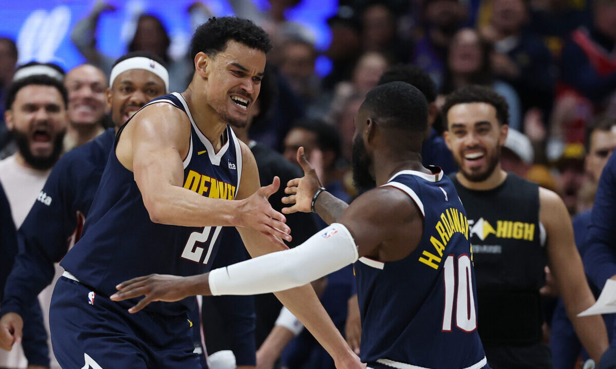 DENVER, COLORADO - APRIL 27: Spencer Jones #21 and Tim Hardaway Jr. #10 of the Denver Nuggets react...