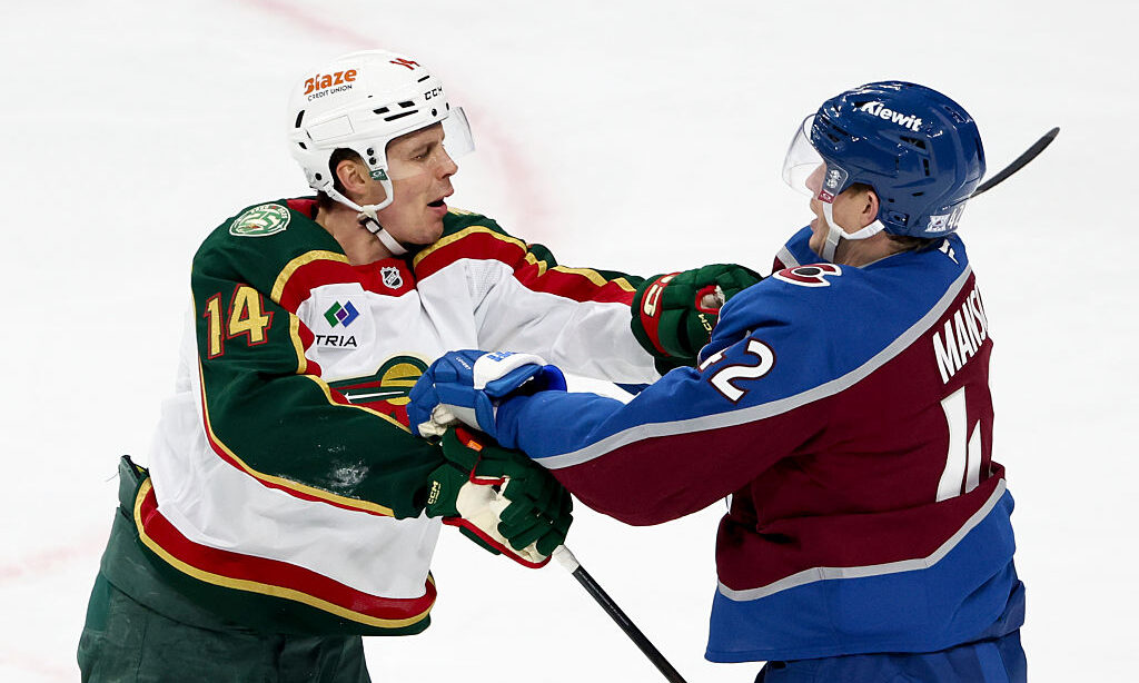 ST PAUL, MINNESOTA - DECEMBER 21: Joel Eriksson Ek #14 of the Minnesota Wild and Josh Manson #42 of...
