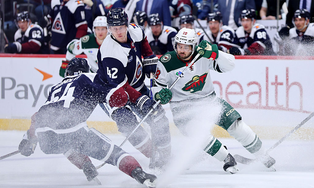 DENVER, COLORADO - FEBRUARY 26: Josh Manson #42 of the Colorado Avalanche and Vinnie Hinostroza #18...