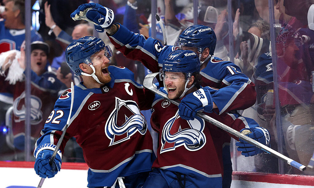 DENVER, COLORADO - MAY 03: Nick Blankenburg #37 of the Colorado Avalanche is congratulated by Gabri...