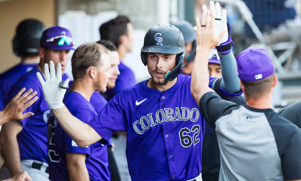 SCOTTSDALE, ARIZONA - MARCH 13: Benny Montgomery #62 of the Colorado Rockies high fives teammates a...