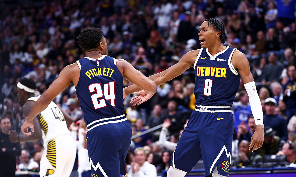 DENVER, COLORADO - NOVEMBER 8: Jalen Pickett #24 and Peyton Watson #8 of the Denver Nuggets high fi...