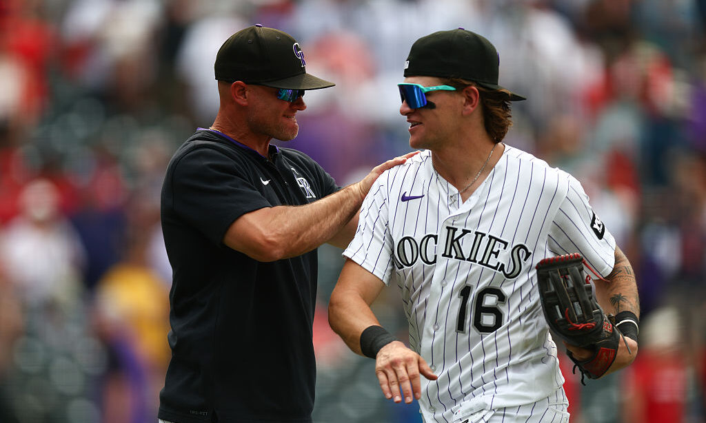DENVER, CO - JUNE 24: Manager Warren Schaeffer #4 of the Colorado Rockies celebrates with Cole Carr...