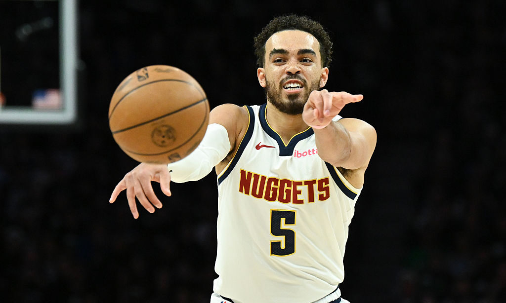 MINNEAPOLIS, MINNESOTA - APRIL 30: Tyus Jones #5 of the Denver Nuggets passes the ball during the s...