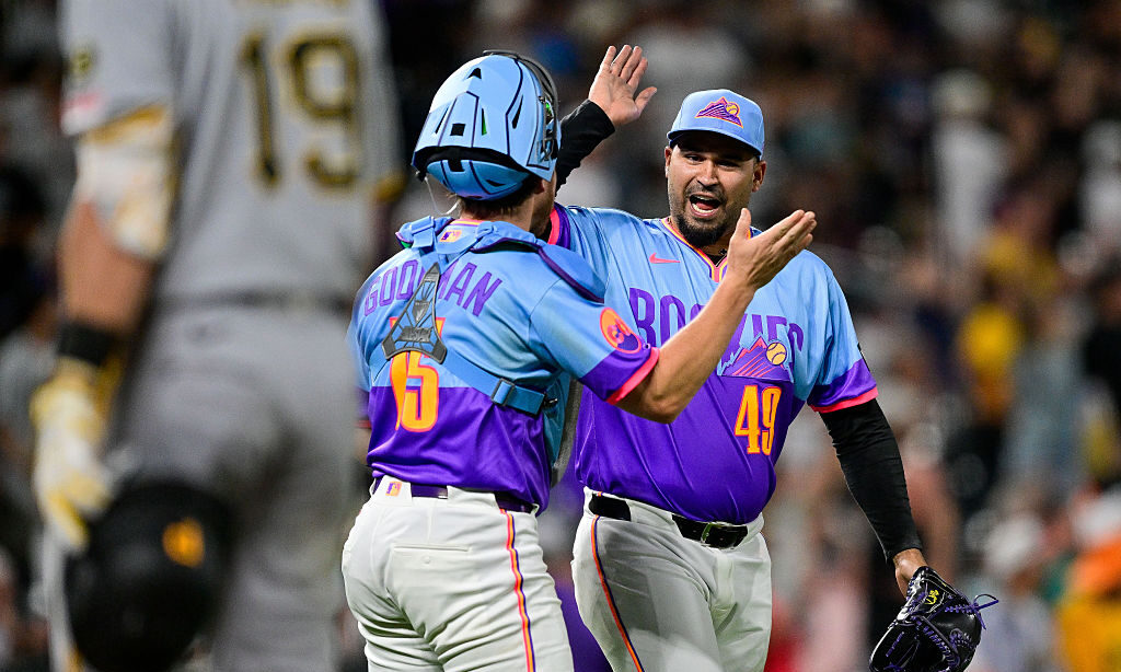 DENVER, COLORADO - JUNE 19: Antonio Senzatela #49 and Hunter Goodman #15 of the Colorado Rockies ce...