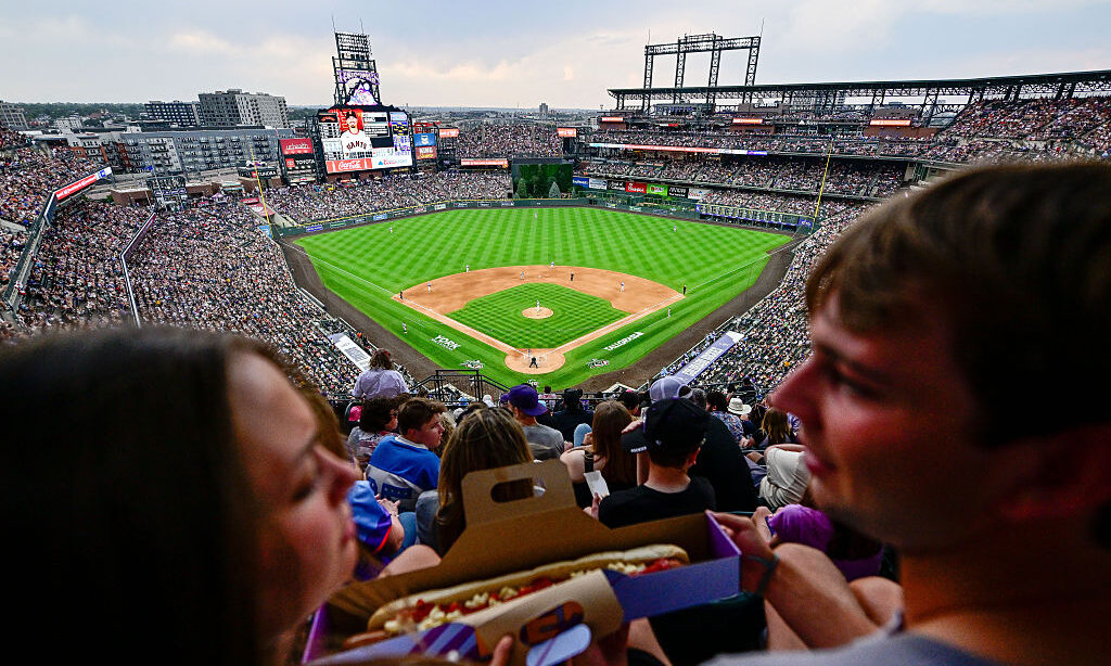 DENVER, COLORADO - JULY 3: Reported attendance of 47,665 fills the stadium as a pair of fans prepar...