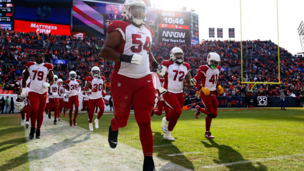 DENVER, COLORADO - DECEMBER 18: Lecitus Smith #54 of the Arizona Cardinals run on to the field prior to the game against the Denver Broncos at Empower Field At Mile High on December 18, 2022 in Denver, Colorado.