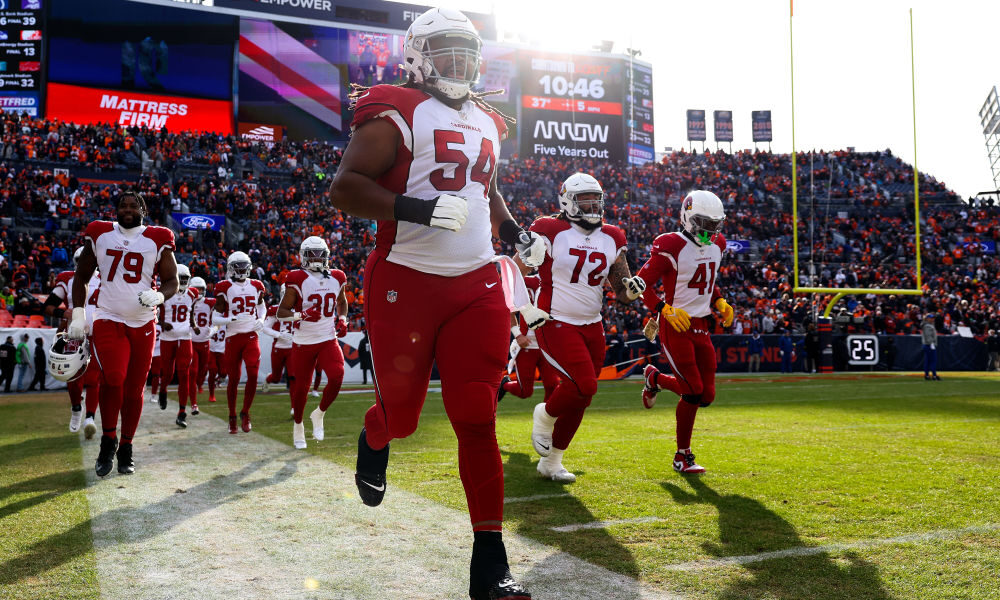 DENVER, COLORADO - DECEMBER 18: Lecitus Smith #54 of the Arizona Cardinals run on to the field prior to the game against the Denver Broncos at Empower Field At Mile High on December 18, 2022 in Denver, Colorado.