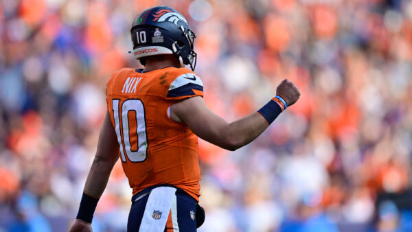 DENVER, COLORADO - OCTOBER 13: Bo Nix #10 of the Denver Broncos reacts after throwing a touchdown pass against the Los Angeles Chargers during the fourth quarter at Empower Field At Mile High on October 13, 2024 in Denver, Colorado.