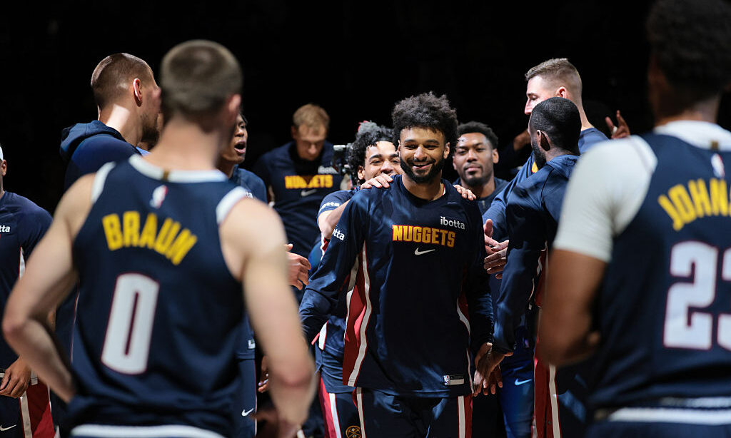 DENVER, COLORADO - OCTOBER 29: Jamal Murray #27 of the Denver Nuggets high fives teammates during i...