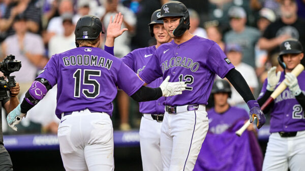 DENVER, COLORADO - AUGUST 1: Hunter Goodman #15 of the Colorado Rockies celebrates with Kyle Karros #12 and TJ Rumfield #7 after his three-run home run in the third inning against the Kansas City Royals at Coors Field on August 1, 2026 in Denver, Colorado.