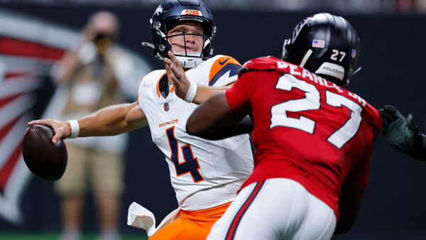 ATLANTA, GEORGIA - AUGUST 14: Sam Ehlinger #4 of the Denver Broncos is pressured by James Pearce Jr. #27 of the Atlanta Falcons during the third quarter in an NFL preseason game at Mercedes-Benz Stadium on August 14, 2026 in Atlanta, Georgia.