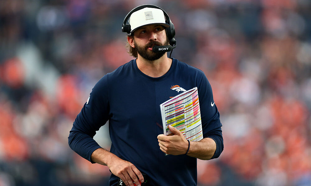 DENVER, CO - AUGUST 28: Offensive coordinator Davis Webb of the Denver Broncos calls in a play during the first quarter against the Minnesota Vikings in a preseason game at Empower Field at Mile High on August 28, 2026 in Denver, Colorado.
