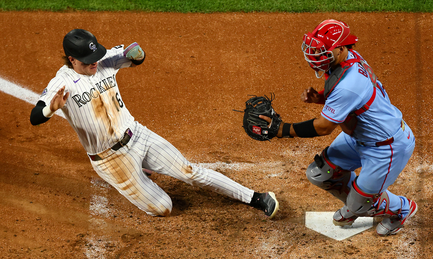 Rockies OF/SS Cole Carrigg slides into home plate...