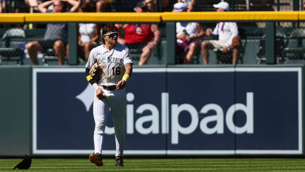 DENVER, CO - SEPTEMBER 6: Cole Carrigg #16 of the Colorado Rockies walks back to retrieve his hat after an error allowed a run to score in the fifth inning against the St. Louis Cardinals at Coors Field on September 6, 2026 in Denver, Colorado.