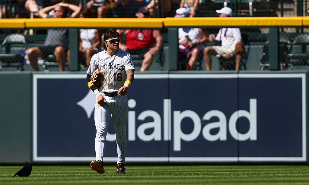 DENVER, CO - SEPTEMBER 6: Cole Carrigg #16 of the Colorado Rockies walks back to retrieve his hat after an error allowed a run to score in the fifth inning against the St. Louis Cardinals at Coors Field on September 6, 2026 in Denver, Colorado.