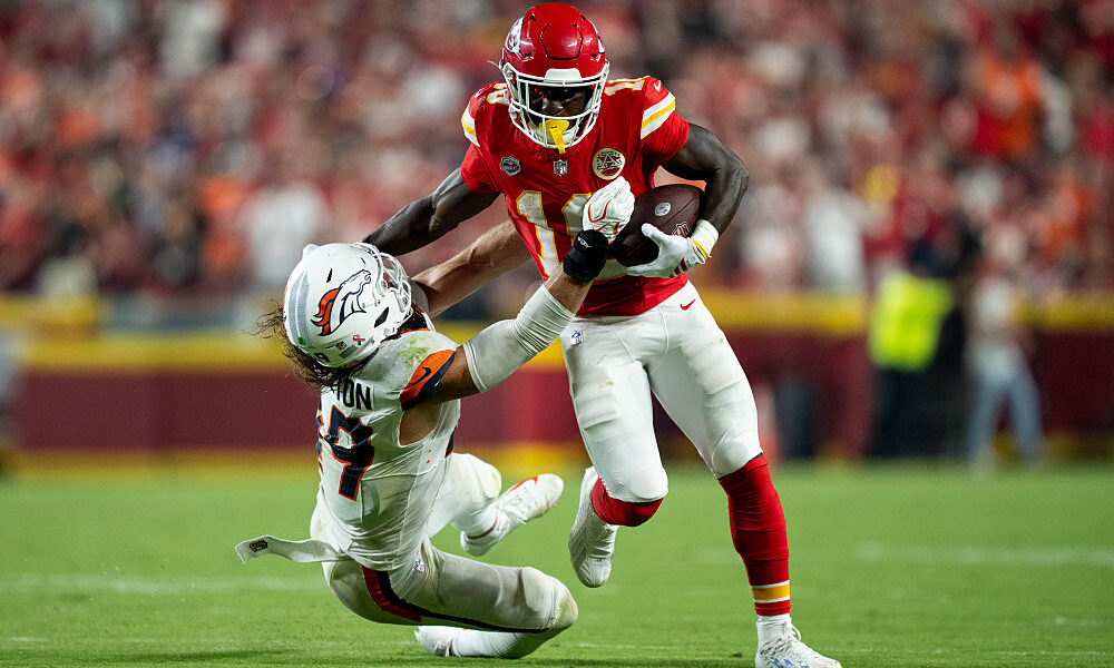 KANSAS CITY, MISSOURI - SEPTEMBER 14: Emmett Johnson #10 of the Kansas City Chiefs stiff arms Alex ...