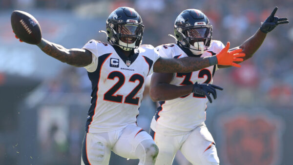 CHICAGO, ILLINOIS - OCTOBER 01: Kareem Jackson #22 and Delarrin Turner-Yell #32 of the Denver Broncos celebrate during the second half against the Chicago Bears at Soldier Field on October 01, 2023 in Chicago, Illinois.