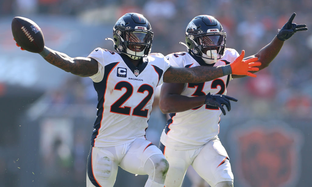 CHICAGO, ILLINOIS - OCTOBER 01: Kareem Jackson #22 and Delarrin Turner-Yell #32 of the Denver Broncos celebrate during the second half against the Chicago Bears at Soldier Field on October 01, 2023 in Chicago, Illinois.