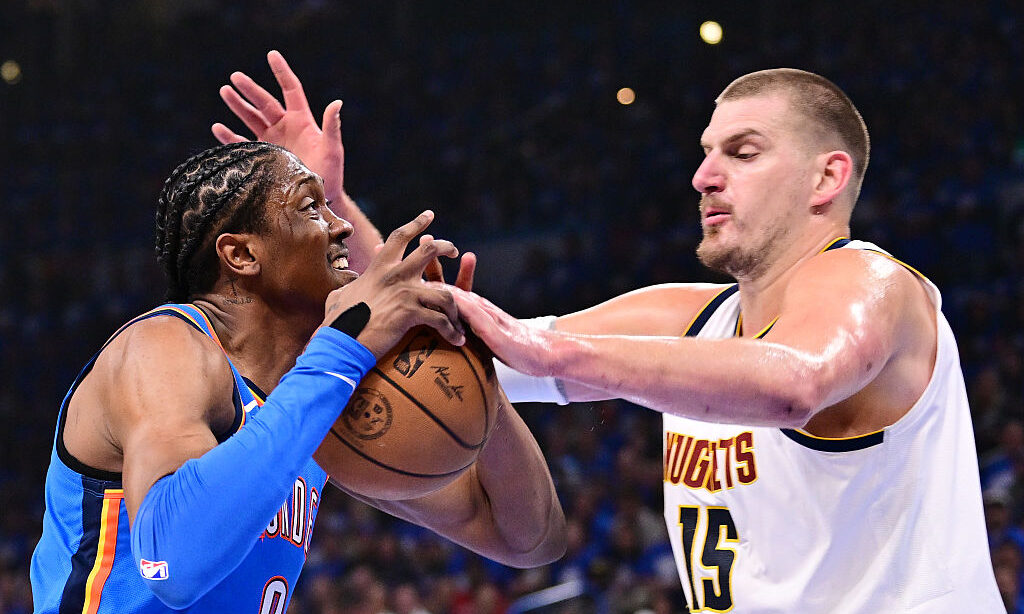 OKLAHOMA CITY, OKLAHOMA - MAY 18: Nikola Jokic #15 of the Denver Nuggets gets a hand on the ball as Jalen Williams #8 of the Oklahoma City Thunder works to maintain possession during the first quarter in Game Seven of the Western Conference Second Round NBA Playoffs at Paycom Center on May 18, 2025 in Oklahoma City, Oklahoma. NOTE TO USER: User expressly acknowledges and agrees that, by downloading and or using this photograph, User is consenting to the terms and conditions of the Getty Images License Agreement.