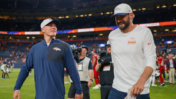 DENVER, CO - AUGUST 16: Bo Nix #10 of the Denver Broncos and quarterbacks coach offensive pass game coordinator/quarterbacks coach Davis Webb share a laugh as they walk off the field after their 27-7 win against the Arizona Cardinals during a NFL Preseason 2025 game at Empower Field at Mile High on August 16, 2025 in Denver, Colorado.