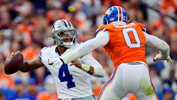 DENVER, COLORADO - OCTOBER 26: Jonathon Cooper #0 of the Denver Broncos pressures Dak Prescott #4 of the Dallas Cowboys during the third quarter in the game at Empower Field At Mile High on October 26, 2025 in Denver, Colorado.
