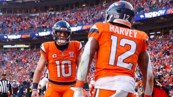 DENVER, COLORADO - DECEMBER 21: Bo Nix #10 celebrates after RJ Harvey #12 of the Denver Broncos scored a third quarter touchdown against the Jacksonville Jaguars at Empower Field At Mile High on December 21, 2025 in
