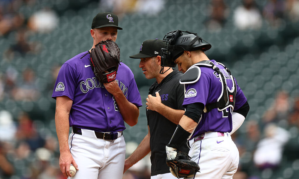 DENVER, CO - SEPTEMBER 17: Starting pitcher Tanner Gordon #29 of the Colorado Rockies talks with Pitching coach Alon Leichman as catcher Brett Sullivan listens in the second inning against the San Diego Padres at Coors Field on September 17, 2026 in Denver, Colorado.