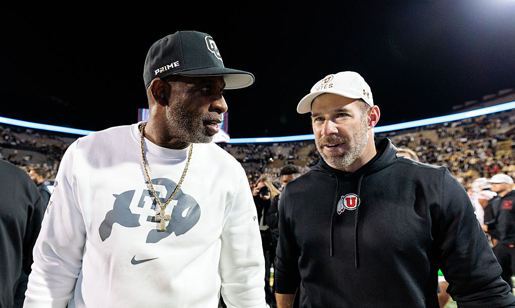 BOULDER, COLORADO - OCTOBER 17: Head coach Deion "Coach Prime" Sanders of the Colorado Buffaloes and Head coach Morgan Scalley of the Utah Utes shake hands after the game at Folsom Field on October 17, 2026 in Boulder, Colorado.
