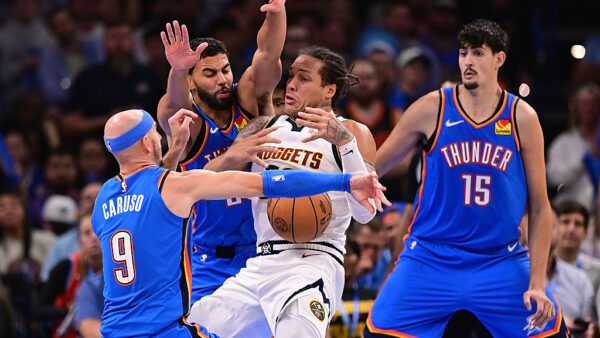 OKLAHOMA CITY, OKLAHOMA - OCTOBER 22: Aaron Gordon #32 of the Denver Nuggets loses the ball while being defended by Ajay Mitchell and Alex Caruso #9 of the Oklahoma City Thunder during the second half at Paycom Center on October 22, 2026 in Oklahoma City, Oklahoma. NOTE TO USER: User expressly acknowledges and agrees that, by downloading and or using this photograph, User is consenting to the terms and conditions of the Getty Images License Agreement.