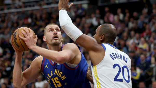 DENVER, COLORADO - OCTOBER 26: Nikola Jokic #15 of the Denver Nuggets goes to the basket against Al Horford #20 of the Golden State Warriors during the first quarter at Ball Arena on October 26, 2026 in Denver, Colorado. NOTE TO USER: User expressly acknowledges and agrees that, by downloading and or using this photograph, User is consenting to the terms and conditions of the Getty Images License Agreement.